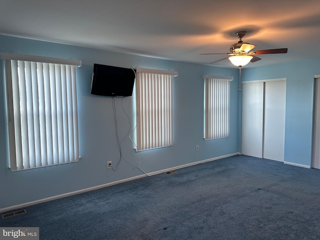 empty room with carpet and ceiling fan