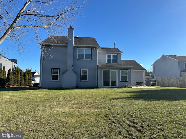 rear view of property featuring a yard and cooling unit