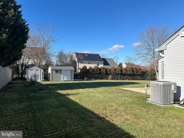 view of yard with a patio area, cooling unit, and a storage shed