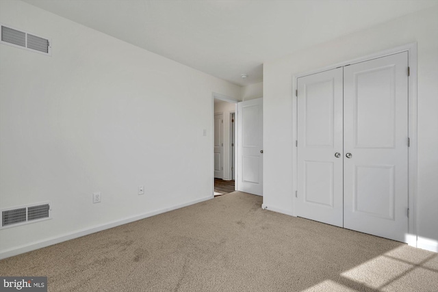 unfurnished bedroom with carpet flooring and a closet