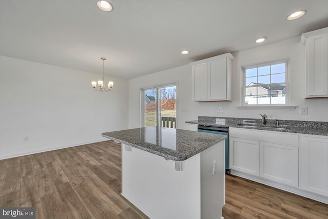 kitchen with white cabinets, plenty of natural light, and sink