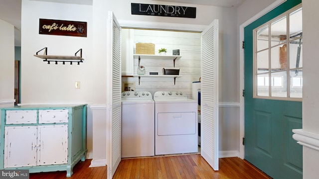 laundry room featuring washer and clothes dryer and light hardwood / wood-style floors