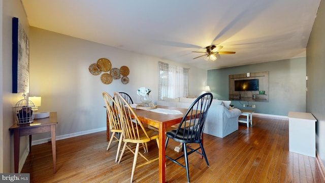 dining space featuring ceiling fan and wood-type flooring