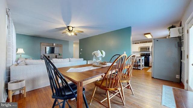 dining space featuring ceiling fan and light hardwood / wood-style floors