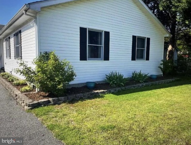 view of side of property with a yard