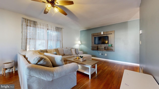 living room with ceiling fan and dark wood-type flooring