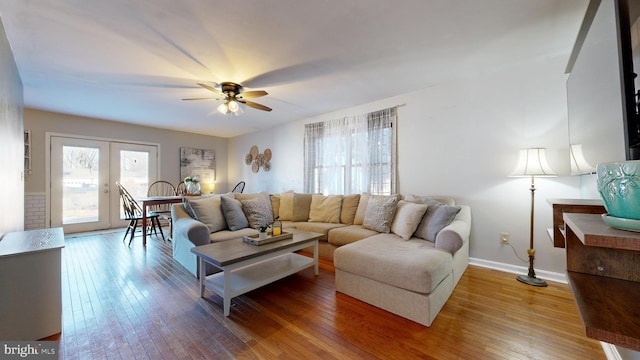 living room with ceiling fan, hardwood / wood-style floors, and french doors