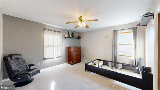 living area featuring ceiling fan