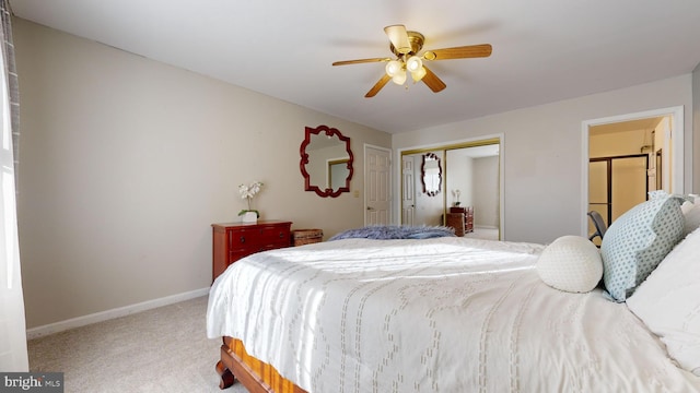 carpeted bedroom featuring ceiling fan and a closet