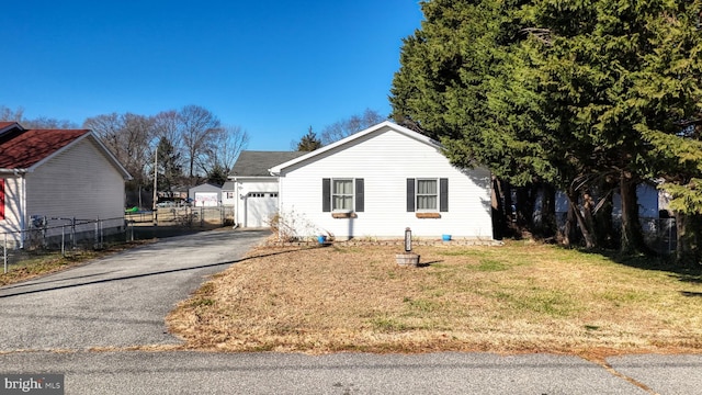 view of front of house with a garage and a front lawn