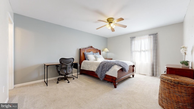 bedroom featuring light carpet and ceiling fan