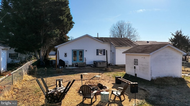 back of house with an outdoor fire pit