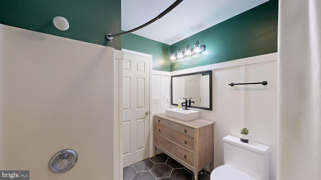 bathroom with tile patterned floors, vanity, and toilet