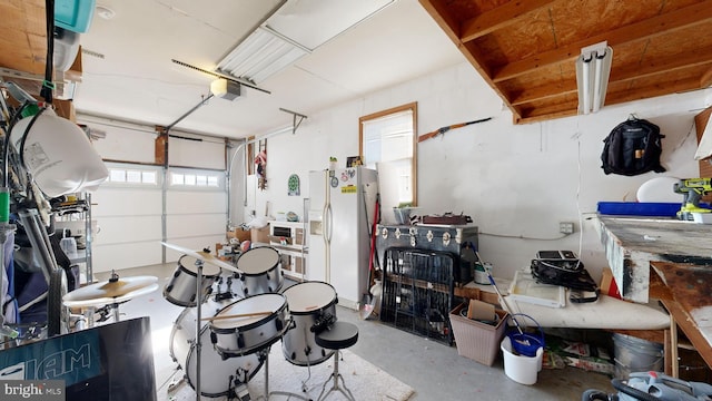 garage with white fridge with ice dispenser and a garage door opener