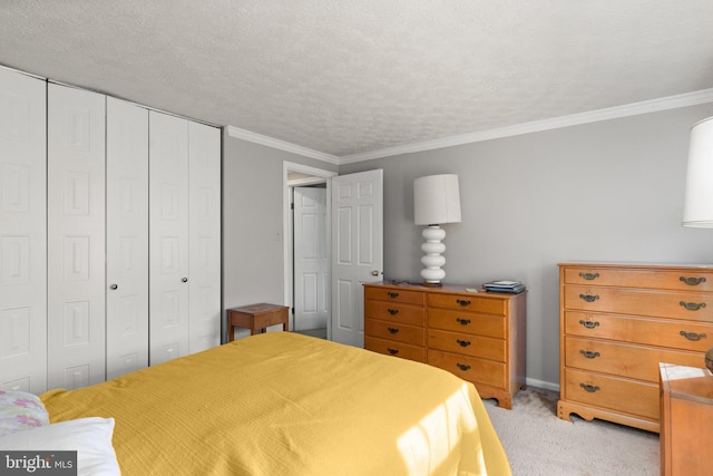 bedroom featuring light carpet, a closet, a textured ceiling, and ornamental molding