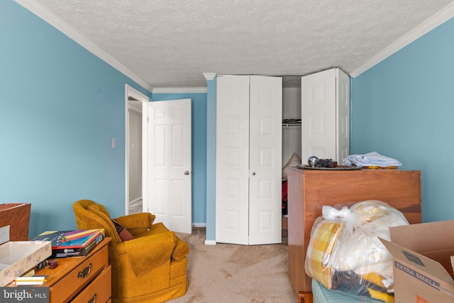 bedroom with a textured ceiling, light colored carpet, a closet, and crown molding