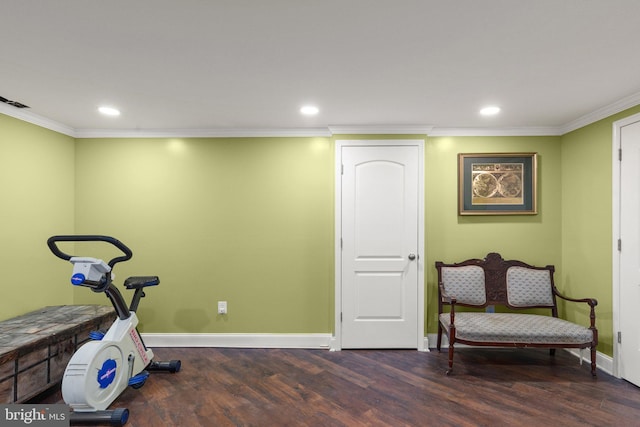 exercise room with crown molding and dark wood-type flooring