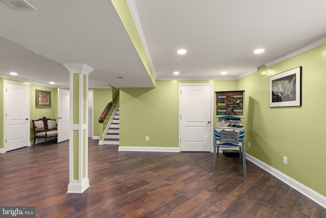 basement with dark hardwood / wood-style flooring and ornamental molding