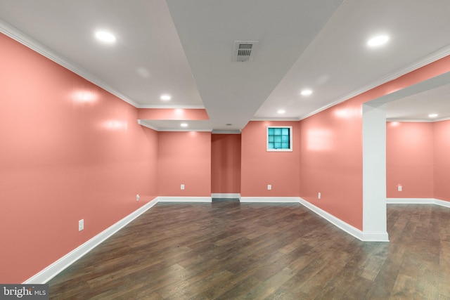 spare room featuring dark hardwood / wood-style floors and ornamental molding