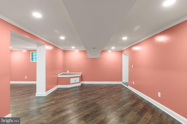 basement featuring crown molding and dark hardwood / wood-style floors