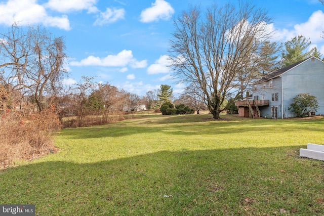 view of yard with a wooden deck