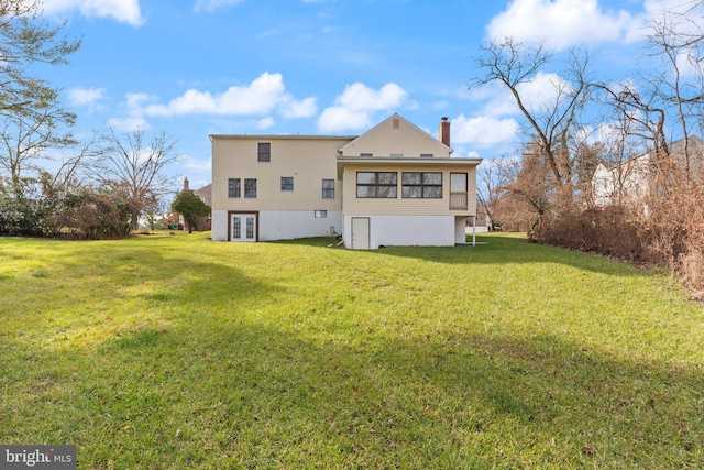 back of property featuring a lawn