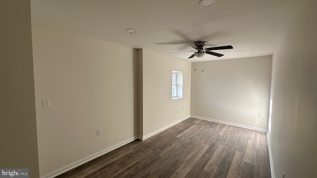 unfurnished room featuring ceiling fan and dark wood-type flooring