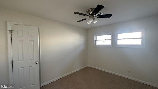 carpeted empty room with ceiling fan