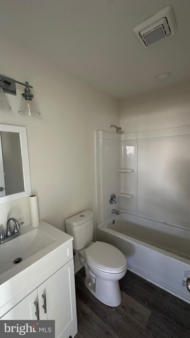 full bathroom featuring shower / tub combination, toilet, vanity, and hardwood / wood-style flooring