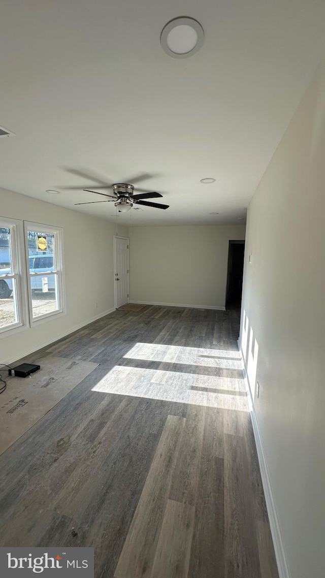 unfurnished room with dark hardwood / wood-style floors and ceiling fan