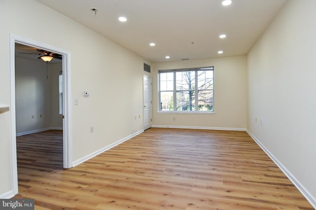 spare room featuring ceiling fan and light wood-type flooring