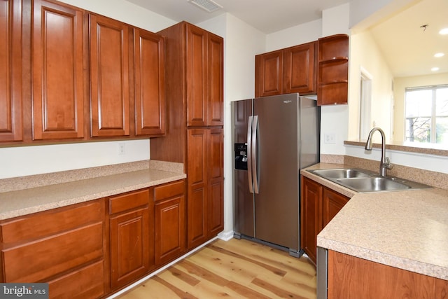 kitchen with stainless steel fridge with ice dispenser, sink, and light hardwood / wood-style flooring