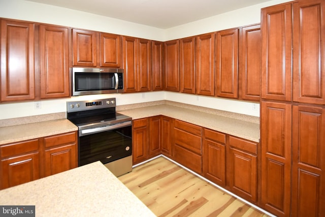 kitchen featuring light hardwood / wood-style flooring and stainless steel appliances