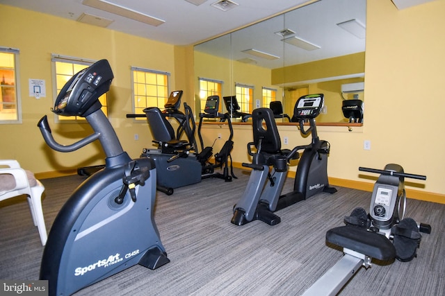 workout area featuring carpet floors and a wall mounted air conditioner