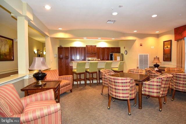 dining space with light colored carpet