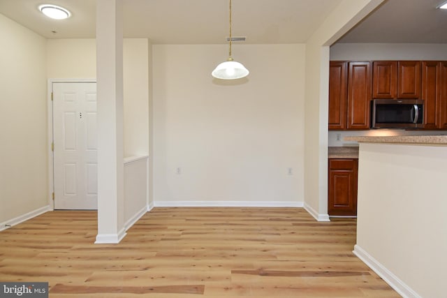 kitchen featuring pendant lighting and light hardwood / wood-style floors