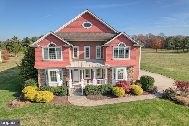 craftsman-style house with a front lawn and covered porch