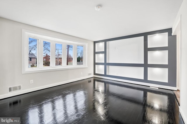 empty room with hardwood / wood-style flooring