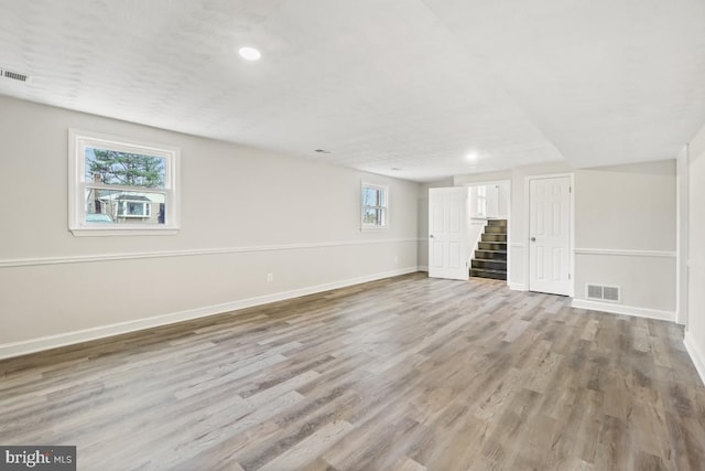 unfurnished room with light hardwood / wood-style floors and a healthy amount of sunlight