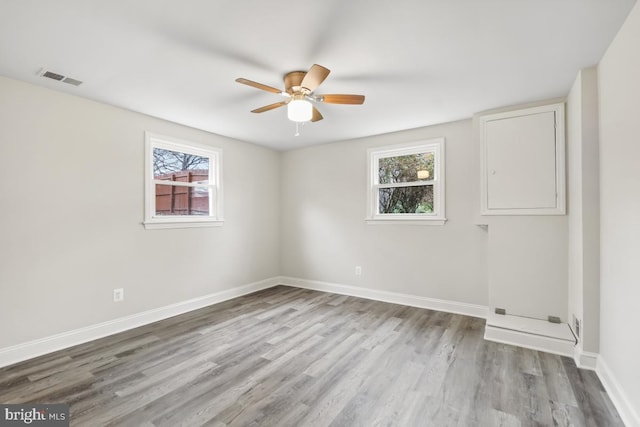 spare room with ceiling fan and light wood-type flooring