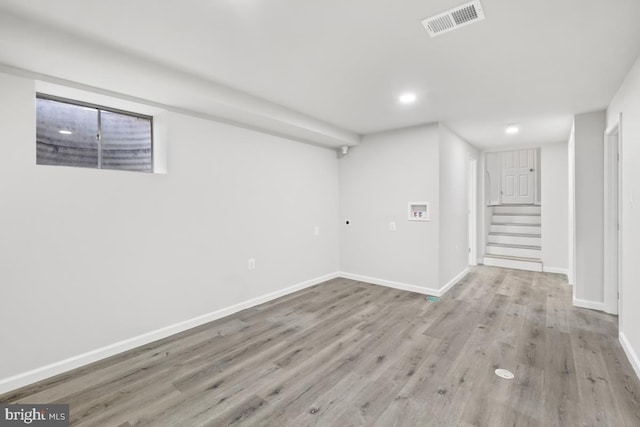 basement with light hardwood / wood-style floors