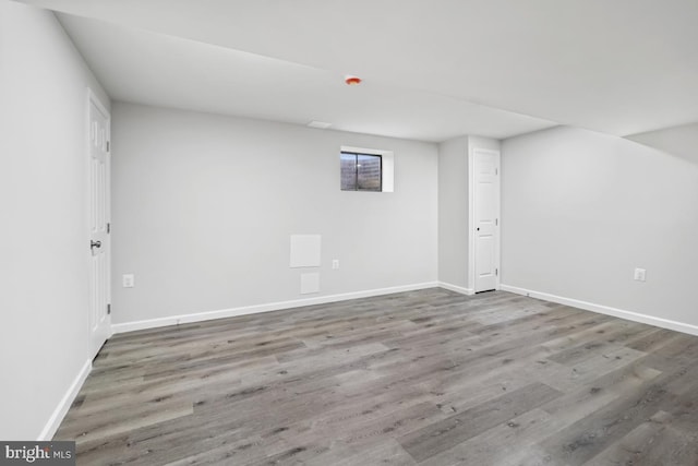 basement with hardwood / wood-style floors