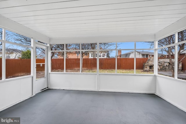 unfurnished sunroom with plenty of natural light and wood ceiling