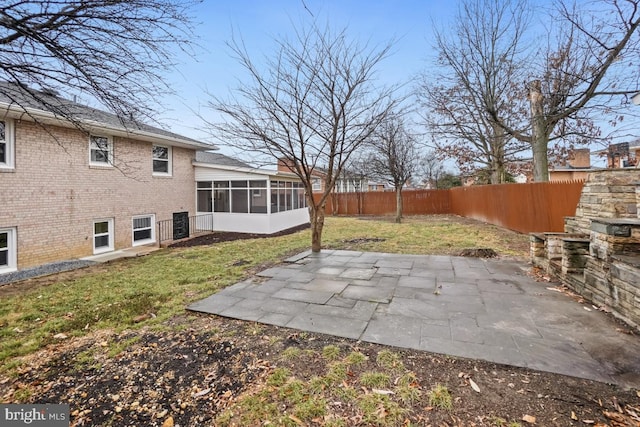 view of yard featuring a patio area and a sunroom