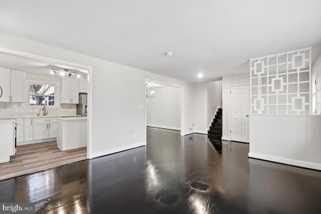 living room with hardwood / wood-style floors and sink