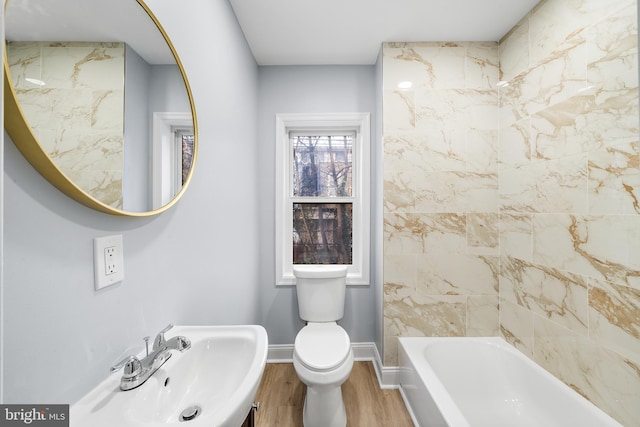 full bathroom with toilet, hardwood / wood-style floors, sink, and shower / bath combination