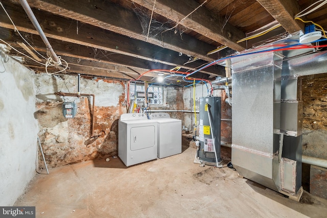 basement with washer and dryer, heating unit, and gas water heater