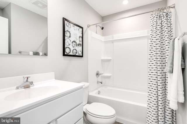 full bathroom featuring shower / bath combo with shower curtain, vanity, and toilet