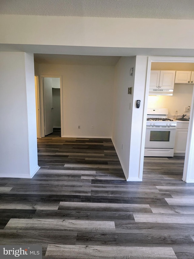 hall with sink and dark wood-type flooring