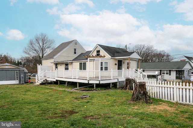 view of front of house featuring a wooden deck, a front yard, and a storage unit